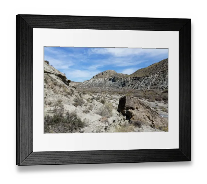 Framed Print : Dry river bed flanked by cliffs of eroded marine and lake sediment layers eroded by seasonal water flow, Tabernas Desert, Almeria, Spain. March, 2024 Framed Print : Dry river bed flanked by cliffs of eroded marine and lake sediment layers eroded by seasonal water flow, Tabernas Desert, Almeria, Spain. March, 2024