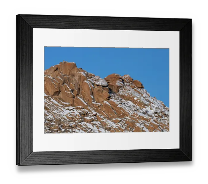 Framed Print : Snow leopard (Panthera uncia) sitting on top of the red granite hills of the Margaz Mountains, Western Mongolia Framed Print : Snow leopard (Panthera uncia) sitting on top of the red granite hills of the Margaz Mountains, Western Mongolia