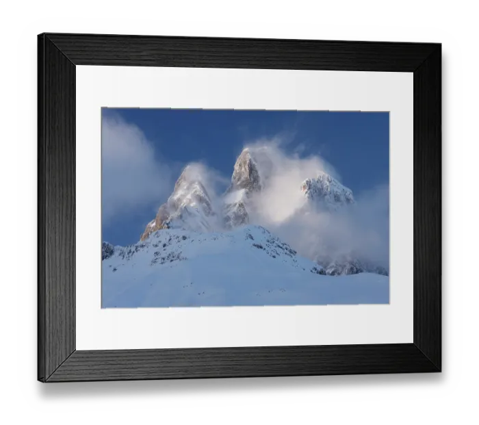 Framed Print : Clouds surrounding the snow-covered Midi d'Ossau peak in the evening, Pyrenees National Park, France. February, 2024