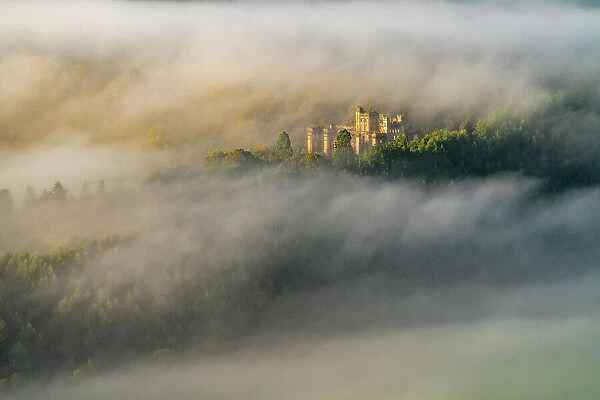Aerial view of Lennox Castle engulfed in fog during a morning inversion, Lennoxtown, East Dunbartonshire, Scotland. October, 2020