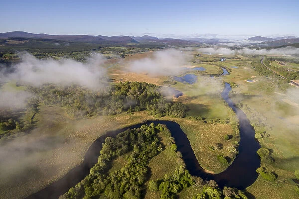 Aerial view of low cloud over the River Spey meandering through Insh marshes, Cairngorms National Park, Scotland, UK. May, 2017