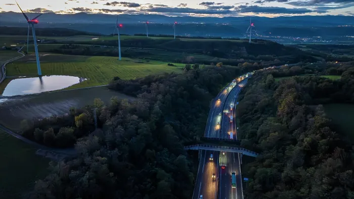 Framed Print : Aerial view of a wildlife crossing over the A7 highway at dusk, built in 2011, with wind turbines along the highway and city of Salaise-sur-Sanne in the distance, Drome, France Framed Print : Aerial view of a wildlife crossing over the A7 highway at dusk, built in 2011, with wind turbines along the highway and city of Salaise-sur-Sanne in the distance, Drome, France