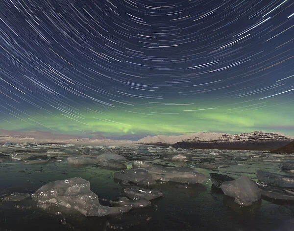 Aurora borealis and star trails over Jokulsarlon glacier lagoon. Southern Iceland