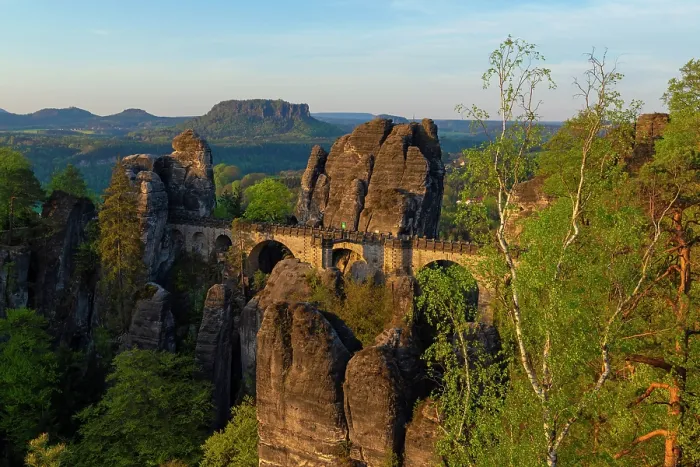 Framed Print : Bastei Bridge surrounded by towering sandstone rock formations and Silver birch (Betula pendula) trees with table mountains in background, Saxon Switzerland National Park, Saxony Framed Print : Bastei Bridge surrounded by towering sandstone rock formations and Silver birch (Betula pendula) trees with table mountains in background, Saxon Switzerland National Park, Saxony