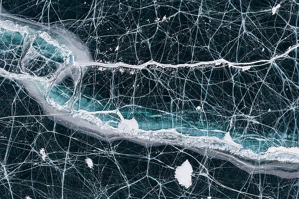 Black ice with cracks on Lake Baikal, aerial shot. Photographed for The Freshwater Project extended. Near Khuzhir, Olchon Island, Irkutsk Oblast and Buryat Republic, Siberia, Russia. February 2019