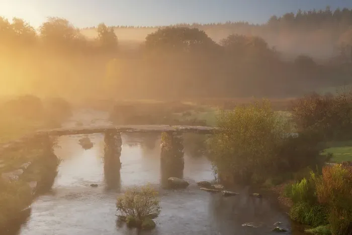 Framed Print : A clapper Bridge across the East Dart river in early morning mist, Dartmoor National Park, Devon, UK. October, 2018 Framed Print : A clapper Bridge across the East Dart river in early morning mist, Dartmoor National Park, Devon, UK. October, 2018