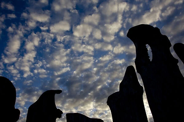 Cloud patterns viewed up through silhouettes of standing stones on blanket bog, Flow country