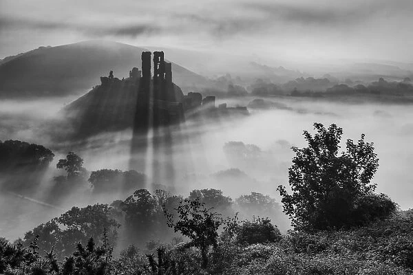 Corfe Castle in morning mist, Corfe, Isle of Purbeck, Dorset, England, UK. September 2013