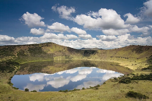 Crater lake with reflections of clouds in the water, Queen Elizabeth National Park