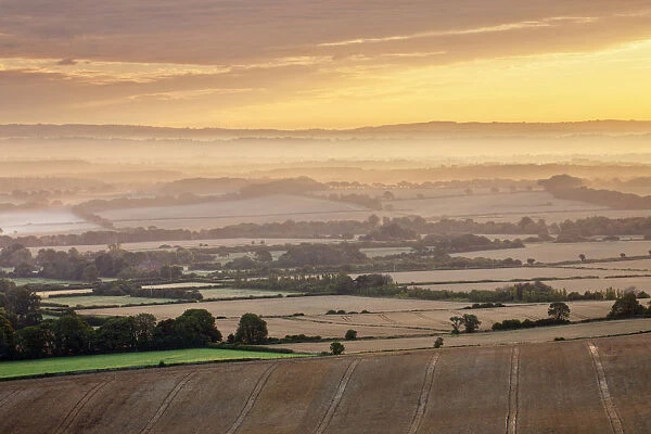 Dawn mist and rolling chalk downland viewed from Wilmington Hill, Wilmington, South