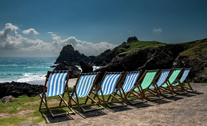 Framed Print : Deck chairs overlooking the National Trust Kynance Cove on a sunny day, Lizard, Cornwall, England, UK. March, 2023