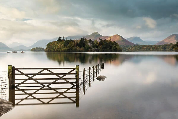 Derwent Water, fence, gate and flooding, looking to Catbells mountain, near Keswick, The Lake District, Cumbria, UK. October 2012