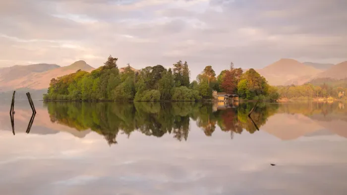 Framed Print : Derwentwater, posts and boathouse, early morning reflections Framed Print : Derwentwater, posts and boathouse, early morning reflections