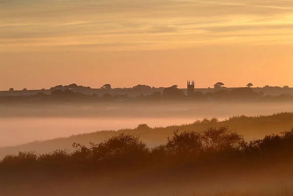 Early morning mist, looking toward Bradworthy village and church, Devon, UK