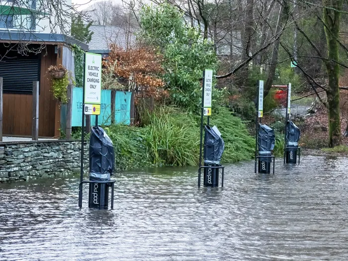 Framed Print : Electric car charging points submerged in water in a flooded carpark after heavy rain, Ambleside, Lake District, Cumbria, UK. January, 2023