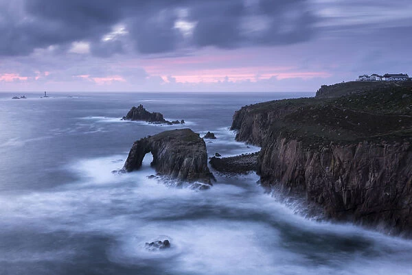 Enys Dodnan Arch, the Armed Knight rock and Longships lighthouse, Lands End, Cornwall, UK