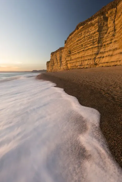 Framed Print : Foam on beach below cliffs at Burton Bradstock, late evening light, Dorset, UK. November 2016 Framed Print : Foam on beach below cliffs at Burton Bradstock, late evening light, Dorset, UK. November 2016