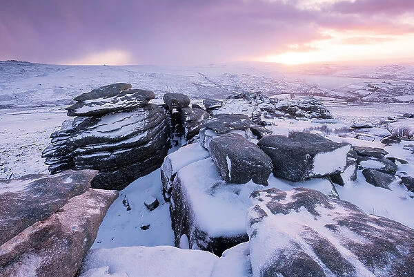 Great Staple Tor covered in snow at dawn, Dartmoor National Park, Devon, England, UK. January 2015
