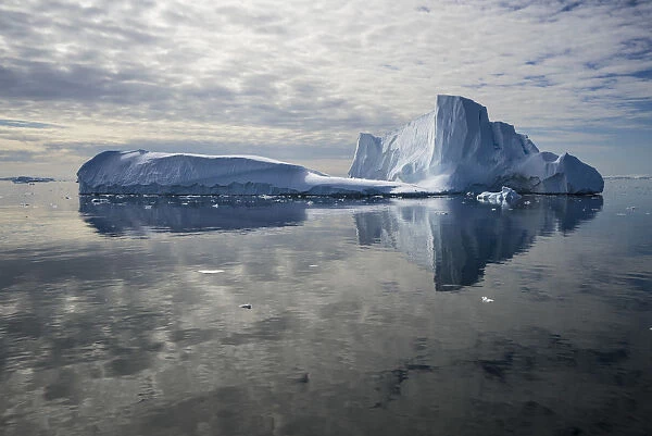 Iceberg reflected in still water of the Crystal Sound, near Detaille Island, Antarctic Peninsula