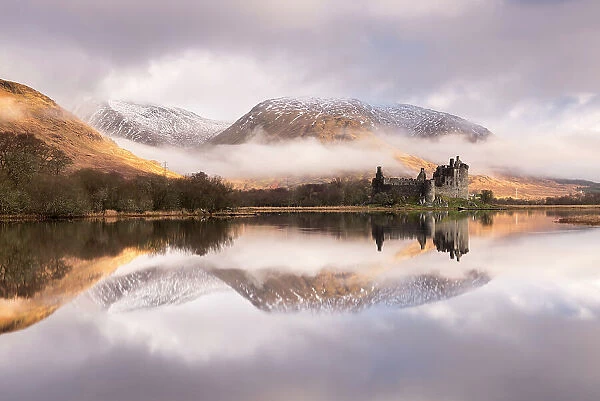 Kilchurn Castle, sunrise, early morning mist and light, a ruin on a rocky peninsula, the northeastern end of Loch Awe, in Argyll and Bute, Scotland, UK. March 2017