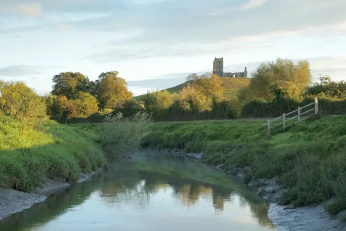 Framed Print : Landscape with river Parrett in foreground and Burrow Mump in background, with ruined church