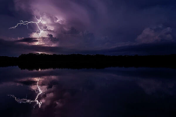 Lightning storm reflecting in river in the Amazon basin, Yasuni National Park, Orellana, Ecuador. January, 2019