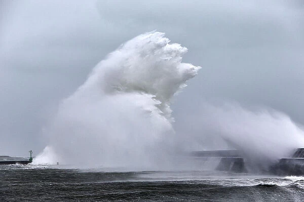Massive wave crashing into Lesconil during Storm Petra, Finistere, Brittany, France