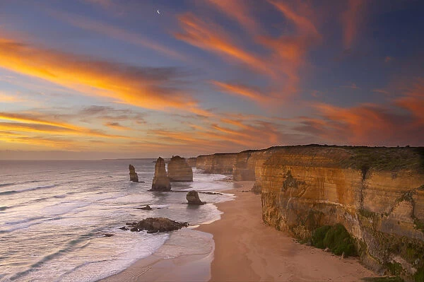 The moon over the eroded coastline of the Twelve Apostles at dusk, Port Campbell National Park