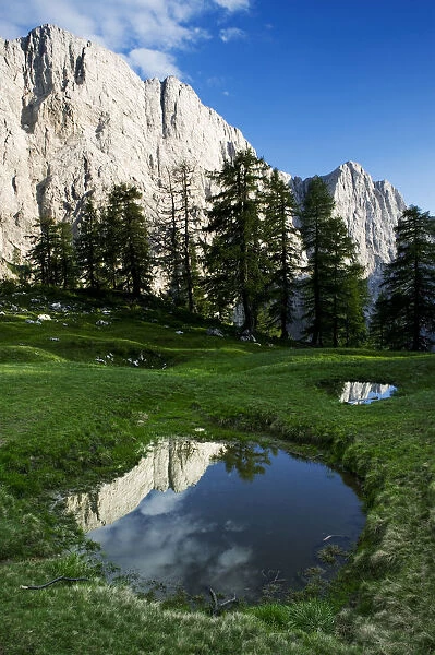 Mount Jalovec (2, 645m) with reflection in a small pool, viewed from Sleme, Triglav National Park