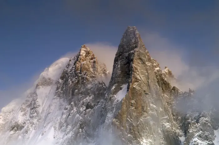 Framed Print : Mountains in snow, Aiguille du Dru with snow blowing off from the top at night. Chamonix