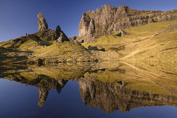 Old Man of Storr reflected in small lochan in morning light