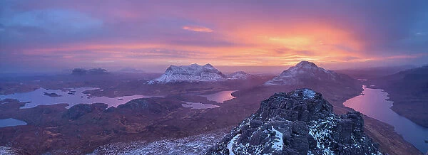 Panoramic view of a colourful winter sunrise from the summit of Stac Pollaidh, Assynt, Highlands of Scotland, UK, January 2016