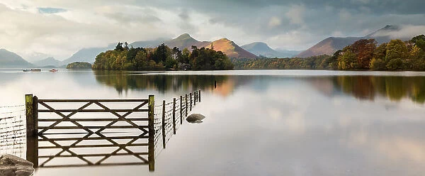 Panoramic view of Derwent Water, fence, gate and flooding, looking to Catbells mountain, near Keswick, The Lake District, Cumbria, UK. October 2012