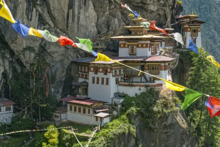 Framed Print : Paro Taktsang / Tigers Nest Buddhist monastery perched on cliffs with prayer flags Framed Print : Paro Taktsang / Tigers Nest Buddhist monastery perched on cliffs with prayer flags