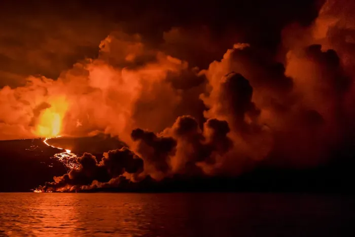 Framed Print : Plume of smoke from Wolf Volcano erupting, with reflections in water, Isabela Island