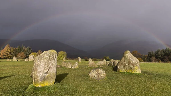 Rainbow and dark skies above Castlerigg Stone Circle, Lake District National Park
