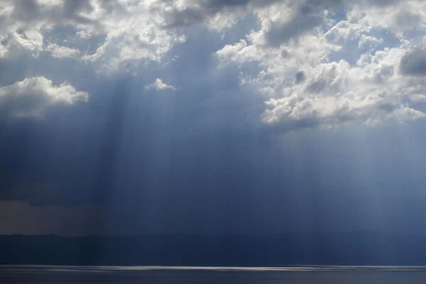 Ray of light shining through thunder clouds over Lake Ohrid, Galicica National Park