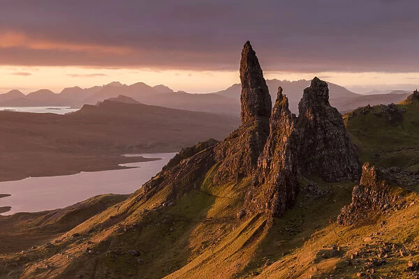 RF - The Old Man of Storr at sunrise, view down to Loch Leathan and mountains. Isle of Skye, Inner Hebrides, Scotland, UK. November 2017. (This image may be licensed either as rights managed or royalty free. )