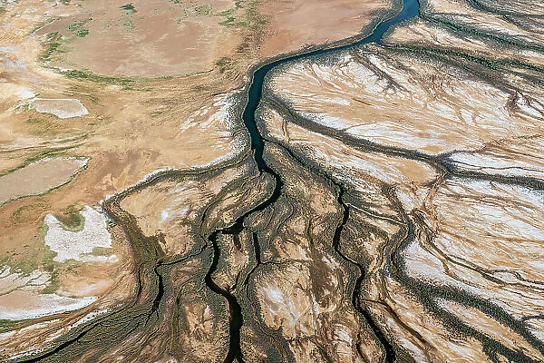Rivers / water channels form and water flows into Lake Eyrer North as a result of uncommonly high desert rainfall. Lake Eyre North, South Australia, March 2022