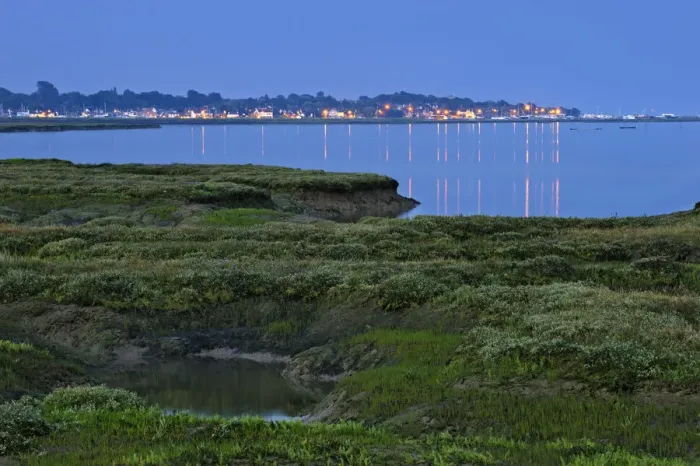 Framed Print : Saltmarsh at twilight, with lights of Bradwell-on-Sea in the background, Abbotts Framed Print : Saltmarsh at twilight, with lights of Bradwell-on-Sea in the background, Abbotts