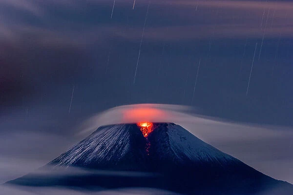 Sangay volcano erupting at night covered in low cloud,   Sangay National Park, Morona Santiago, Ecuador.   June, 2020