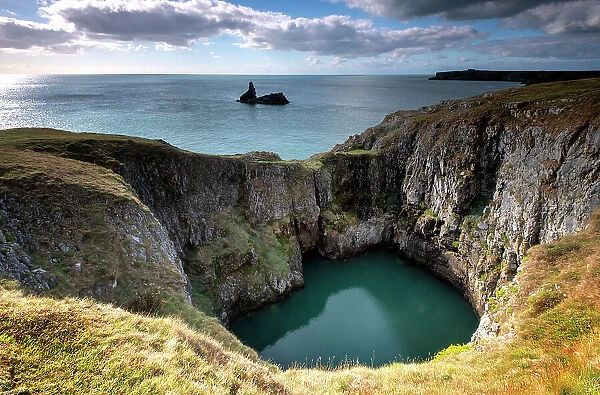 A sink hole, created by collapse of Carboniferous limestone cave roof, Bosherton, Pembrokeshire, Wales, UK. September, 2022