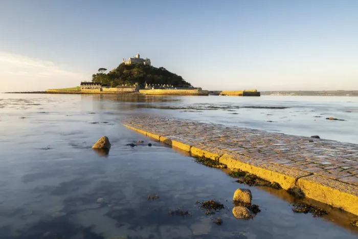 Framed Print : St Michaels Mount in morning light, cobbled causeway underwater at high tide Framed Print : St Michaels Mount in morning light, cobbled causeway underwater at high tide