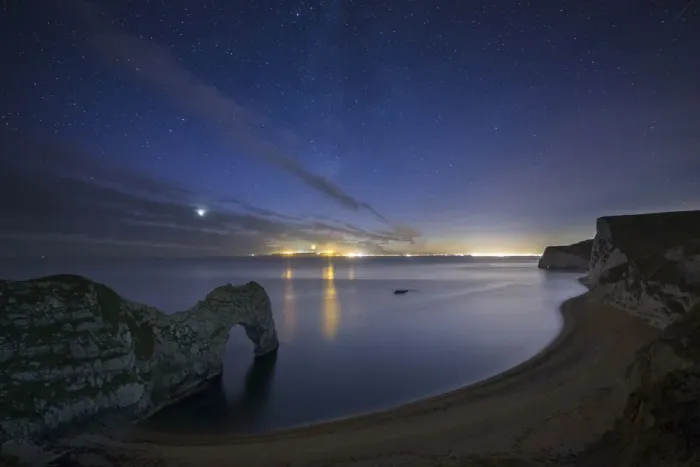 Framed Print : Stars and Milky Way over Durdle Door and the Jurassic Coast, with the lights of Weymouth Framed Print : Stars and Milky Way over Durdle Door and the Jurassic Coast, with the lights of Weymouth