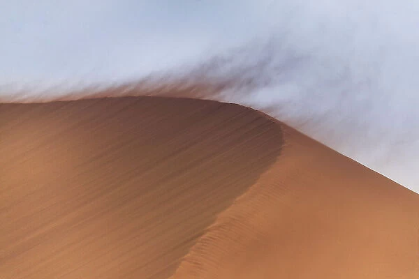 Very strong wind blowing sand from summit of dune 45, Namib Desert, Namib - Nauckluft National Park. Namibia