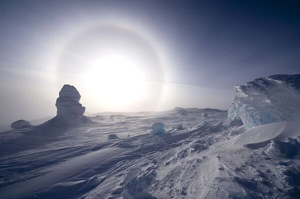 Sundog  /  Parhelion (circle of light around the sun) with large ice fumerole in the foreground