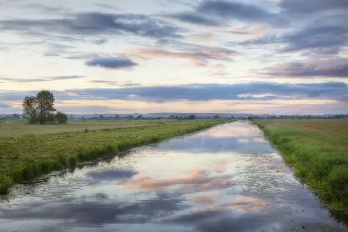 Framed Print : Sunrise with reflection of clouds in Kings Sedgemoor Drain, Greylake, Somerset Levels