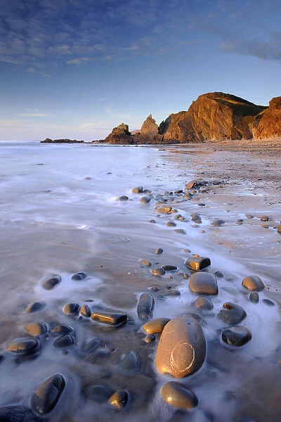 Tide washing over pebbles at Sandymouth bay, north Cornwall, UK. January 2009