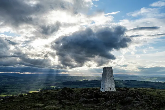 Framed Print : Titterstone Clee Hill summit and the trig point and shafts of sunlight emerging from dark clouds, Shropshire Hills National Landscape, England, UK. April, 2024 Framed Print : Titterstone Clee Hill summit and the trig point and shafts of sunlight emerging from dark clouds, Shropshire Hills National Landscape, England, UK. April, 2024