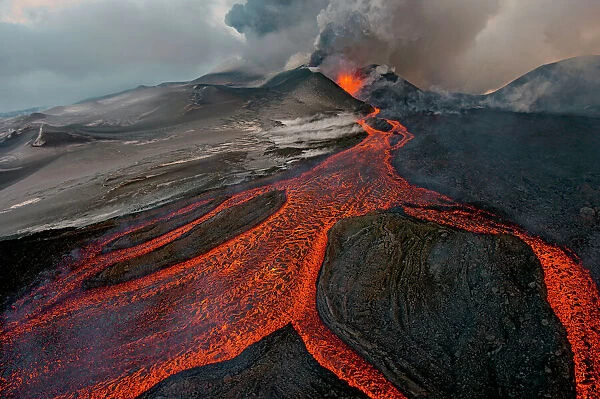 Tolbachik Volcano erupting with lava flowing down the mountain side. Kamchatka, Russia